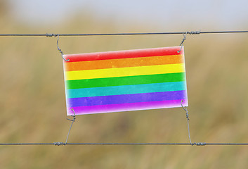 Image showing Border fence - Old plastic sign with a flag