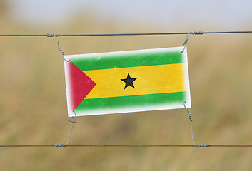 Image showing Border fence - Old plastic sign with a flag