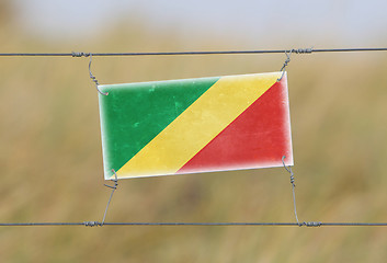 Image showing Border fence - Old plastic sign with a flag