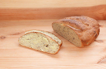 Image showing Buttered slice of bread with the remaining loaf 