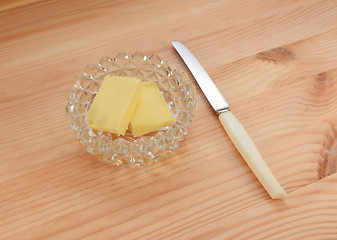 Image showing Butter in a glass dish with a small knife for spreading