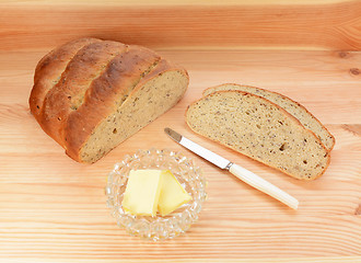 Image showing Slices of fresh bread with pats of butter 