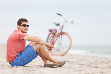 Image showing man biking at the beach