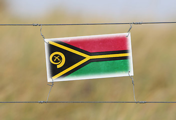 Image showing Border fence - Old plastic sign with a flag