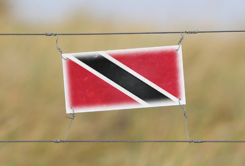 Image showing Border fence - Old plastic sign with a flag