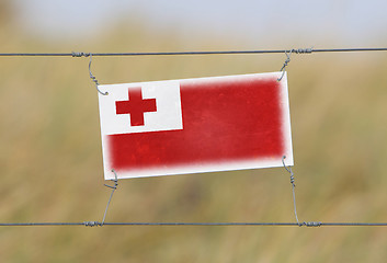 Image showing Border fence - Old plastic sign with a flag