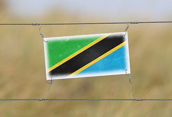 Image showing Border fence - Old plastic sign with a flag