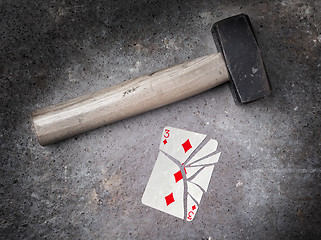 Image showing Hammer with a broken card, three of diamonds