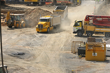 Image showing Trucks rumble into a construction site
