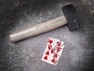 Image showing Hammer with a broken card, nine of hearts