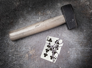 Image showing Hammer with a broken card, nine of clubs