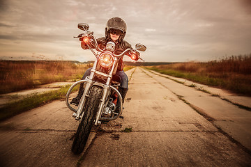 Image showing Biker girl on a motorcycle