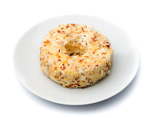 Image showing Round sweet dessert cheese with nuts and pineapple on a white pl