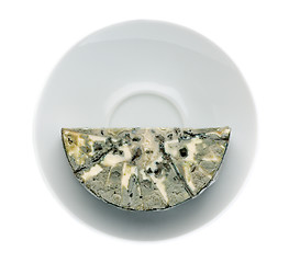 Image showing Cheese with black mold on the plate. View from above.