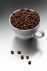 Image showing Cup of coffee, full of beans.