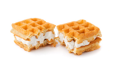 Image showing Waffle with cream a broken in half.