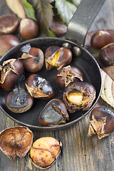 Image showing Frying pan with roasted chestnuts closeup.