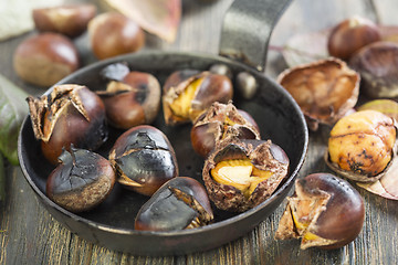 Image showing Roasted chestnuts closeup in a frying pan.