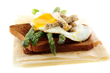 Image showing Rye bread with asparagus, eggs and turkey.