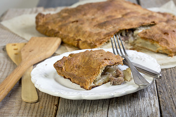 Image showing Pie with meat and potatoes on the plate.