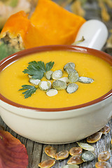 Image showing Pumpkin soup with seeds and parsley.