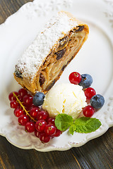 Image showing Strudel with apples, ice cream and berries.