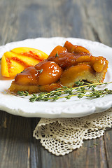 Image showing Plate with peach pie and thyme.