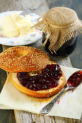 Image showing Bagel with butter and jam for breakfast.