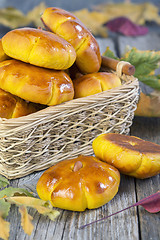 Image showing Basket with pumpkin buns.