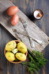Image showing Potatoes, dill, salt shaker and forks.