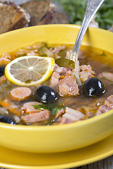 Image showing Thick meat soup and a spoon in a plate.