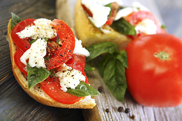 Image showing Ciabatta with tomatoes, cheese and basil close-up.