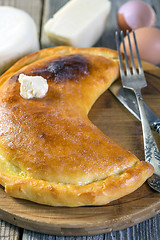 Image showing Cheese pie with a slice of butter.