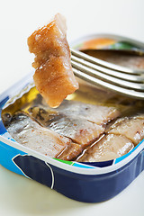 Image showing Slice of herring on a fork closeup.