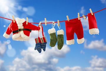 Image showing Clothing Santa's on the rope.