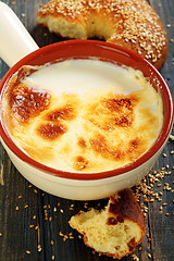 Image showing Homemade fermented baked milk and bagel with sesame seeds.