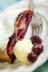 Image showing Plate with cherry strudel and fork.