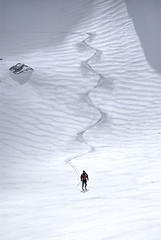 Image showing Male skier riding down the hill