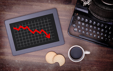 Image showing Tablet touch computer gadget on wooden table, graph negative