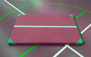 Image showing Very old red mat on a blue court
