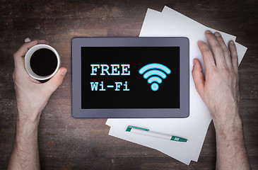 Image showing Tablet with Wi-Fi connection on a wooden desk