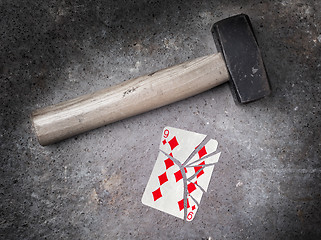 Image showing Hammer with a broken card, nine of diamonds