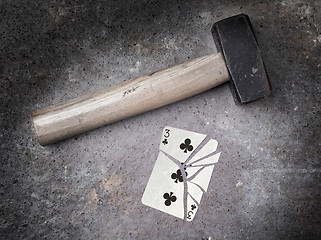 Image showing Hammer with a broken card, three of clubs