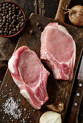 Image showing fresh raw meat on wooden cutting board