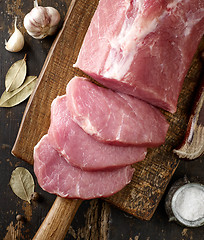 Image showing fresh raw meat on wooden cutting board