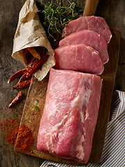 Image showing fresh raw meat on wooden cutting board