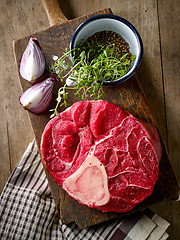 Image showing fresh raw meat on wooden cutting board