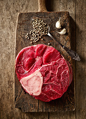 Image showing fresh raw meat on wooden cutting board