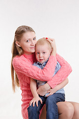 Image showing Young mother calms her son