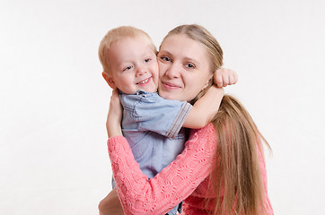 Image showing The three-year boy hugging his mother